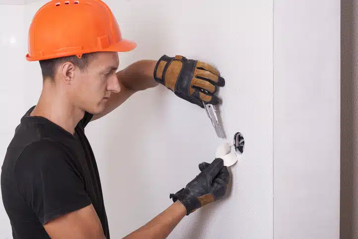 Electrician installs lighting switch